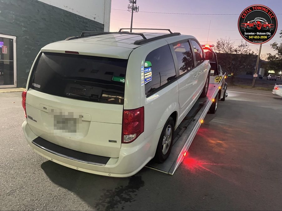 CSTLL Towing transporting a minivan on the flatbed